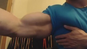 Bodybuilder Flexing and Measuring Big Biceps